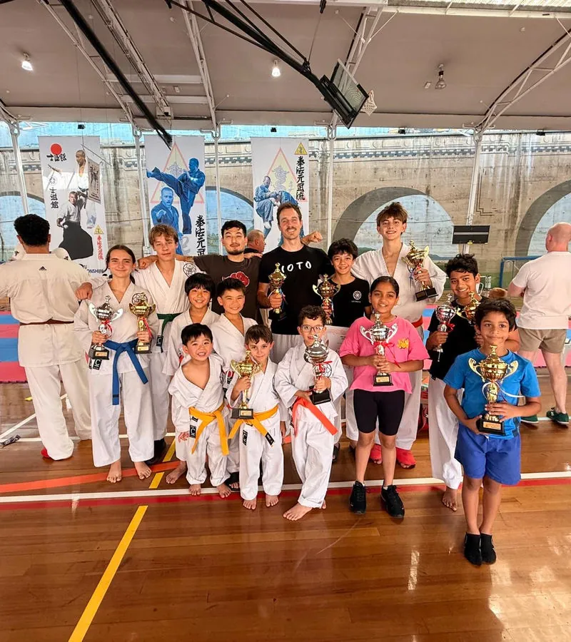Harrison Saito teaching a group of young students in a dojo
