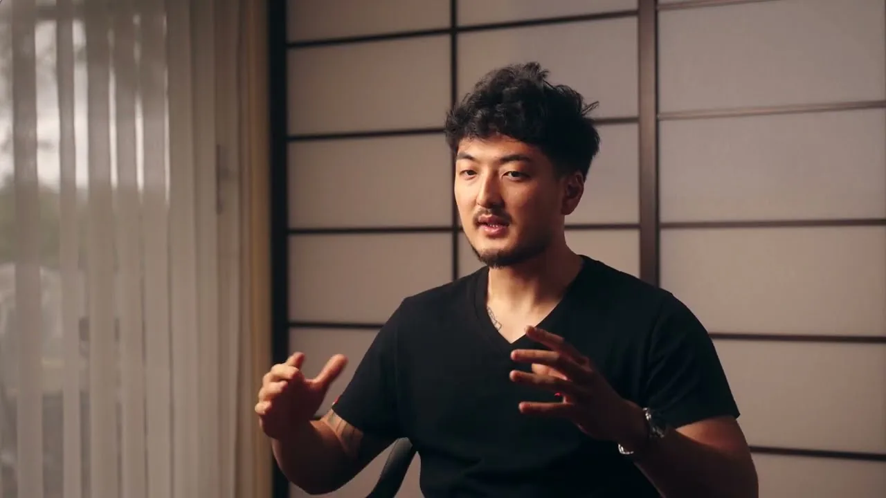 Harrison Saito seated against a shoji screen