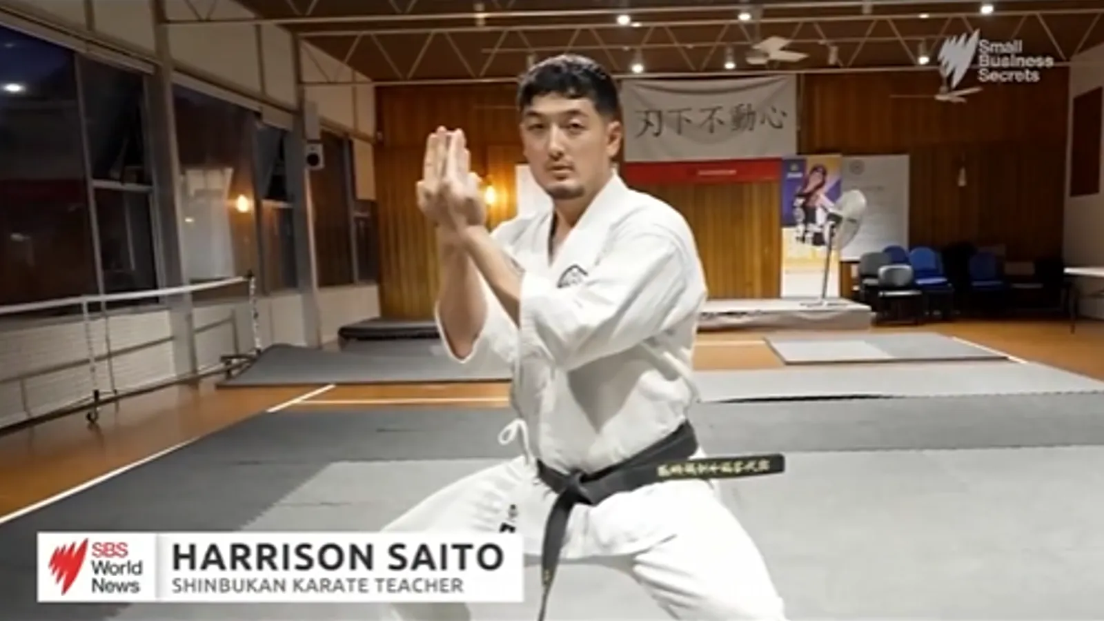 Harrison Saito in his gi at the Shinbukan dojo, in the SBS World News feature that names him as a karate teacher
